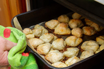 Ready hot curd cookies lying on a baking sheet in the oven