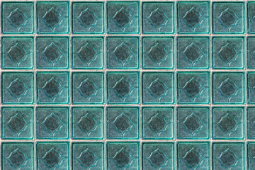 Seamless pattern texture of a white glass transparent wall from square bricks in blue hue on the photo