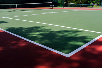 Tennis Court And Net In Red And Green Outside