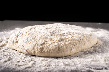 dough with flour on a black background