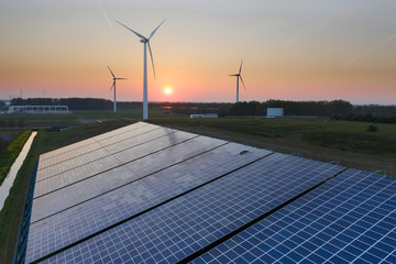 Wind turbines and solar panels generating green energy during sunset as seen from above in Waalwijk, Noord Brabant, Netherlands