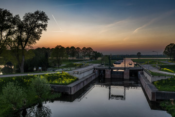 Fototapeta na wymiar A small water lock in a canal near Waalwijk, Noord Brabant, Netherlands