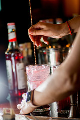 female bartender preparing cocktail in a cocktail bar