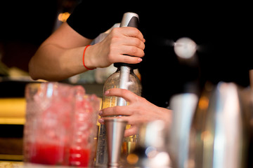 female bartender preparing cocktail in a cocktail bar