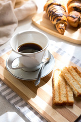 Continental breakfast - coffee, orange juice and toast on white wood table. Background with free text space.
