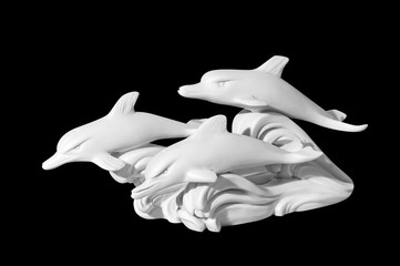 statue of dolphins on a black background