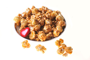 Healthy food. Diet popcorn isolated on white background. Red heart. Close-up