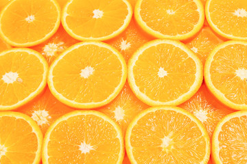 Slices of oranges as a background, top view.