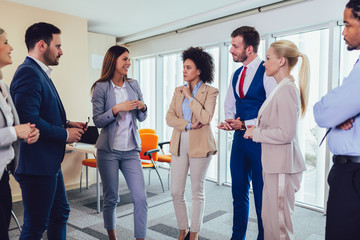 Business team having a meeting standing in the office. Selective focus.