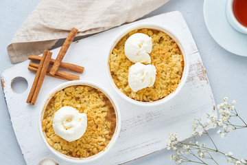 Apple crumble with ice cream, streusel, a flowers. Top view, close up