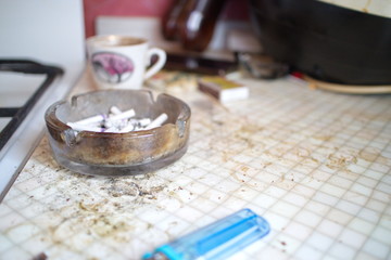 Obraz na płótnie Canvas ashtray and lighter on a dirty table