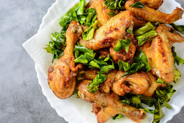 Fried crispy chicken wings with herbs