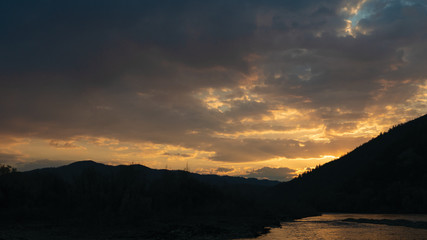 sunset in the mountains by the river Ukraine