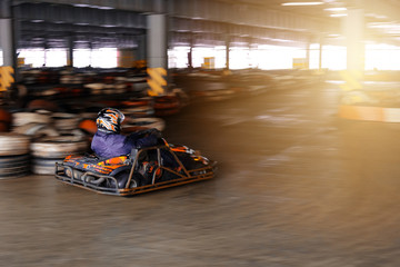 Dynamic karting competition at speed with blurry motion on an equipped racecourse