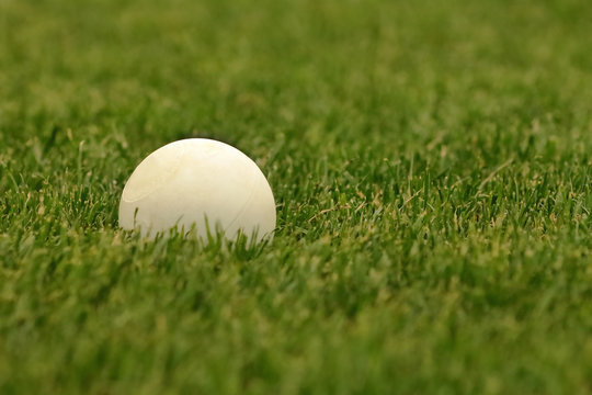 Close up picture of lacrosse balls on the green field.