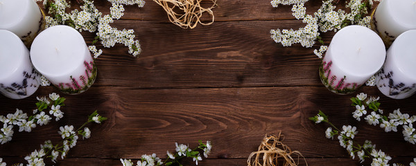 relaxation and spa floral concept with candles on wooden background
