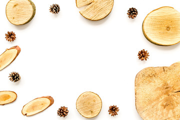 wooden saw cut and pine cone frame on white background to view mockup