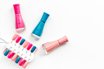 decorative cosmetics set with nail polish and palette for manicure on white background top view space for text