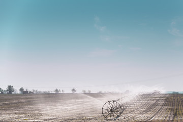 large wheels with sprinklers for irrigation in the field