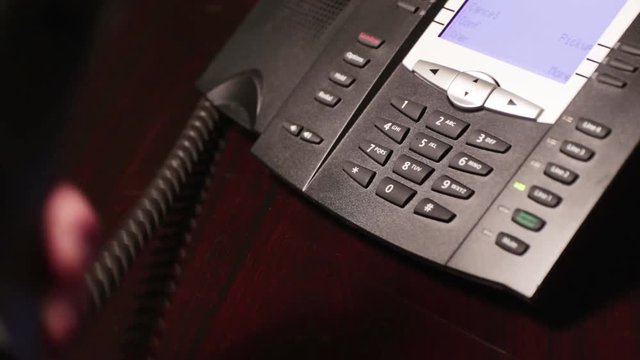 Finger dialing "0" for operator on touch tone telephone.