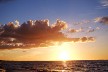 Deeply orange sunset at the calm seaside