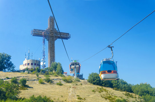POV view of tourist on ride of gondola cablecar to Vodno mountain and world largest cross