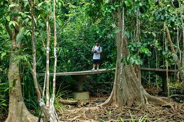 A young man takes pictures while traveling.