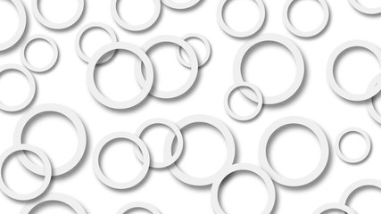 Abstract illustration of randomly arranged gray rings with soft shadows on white background