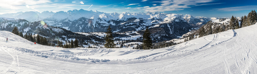 Fototapeta na wymiar People skiing in Mythenregion ski resort, Ibergeregg, Switzerland, Europe.