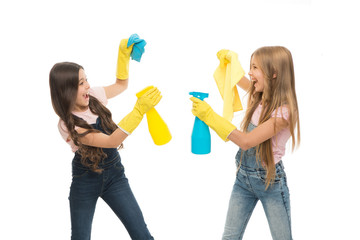 Household duties. Little helper. Girls cute kids cleaning around with mist sprayer. Keep it clean. Sisters rivalry. Who did better. Girls with yellow rubber protective gloves ready for cleaning