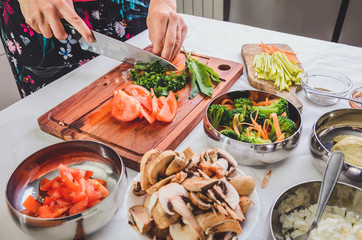 Female hands chopping vegetables, preparing ingredients for a delicious meal