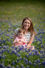 Young Millennial Mother With Daughter During Spring in a Field of Blue Bonnets