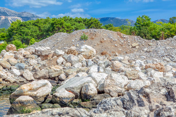 summer scenery with big stones on the littoral