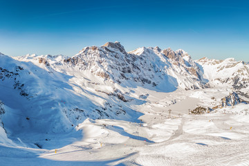 Fototapeta na wymiar Beautiful winter landscape with Swiss Alps. Skiers skiing in famous Engelgerg - Titlis ski resort, Switzerland, Europe