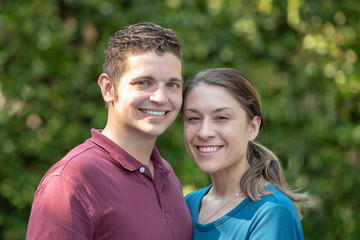 Obraz premium Young Millennial Couple Posing for a Portrait Outside in the Summer