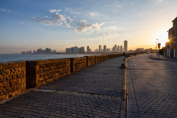 Beautiful view of the side walk on the ocean coast during a sunny sunrise. Taken in Jaffa Old City,...