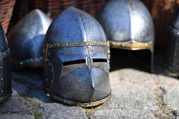 Shiny knight helmets on a traditional market.