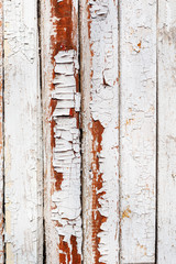 old wooden wall with peeling white paint