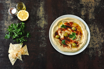 Fresh homemade hummus with olive oil and spices. Middle Eastern cuisine.