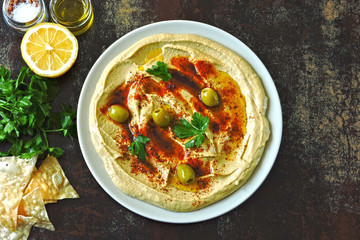 Fresh homemade hummus with olive oil and spices. Middle Eastern cuisine.