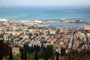Beautiful view of Bahai Gardens and a city on the coast of Mediterranean Sea during a cloudy day. Taken in Haifa, Israel.