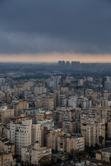 Obraz premium Aerial view of a residential neighborhood in a city during a cloudy sunrise. Taken in Netanya, Center District, Israel.