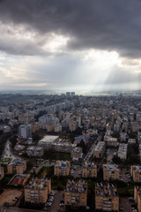 Aerial view of a residential neighborhood in a city during a cloudy sunrise. Taken in Netanya, Center District, Israel.