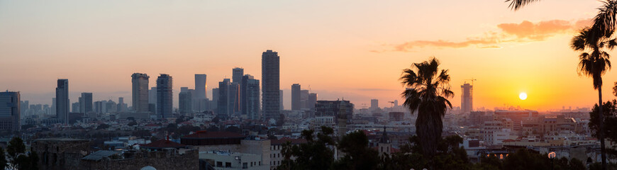 Panoramic view of a modern downtown city during a sunny sunrise. Taken in Jaffa, Tel Aviv-Yafo,...