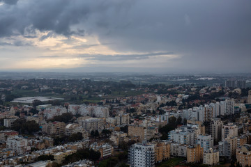 Obraz premium Aerial view of a residential neighborhood in a city during a cloudy sunrise. Taken in Netanya, Center District, Israel.