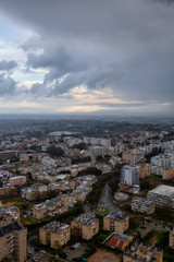 Obraz premium Aerial view of a residential neighborhood in a city during a cloudy sunrise. Taken in Netanya, Center District, Israel.