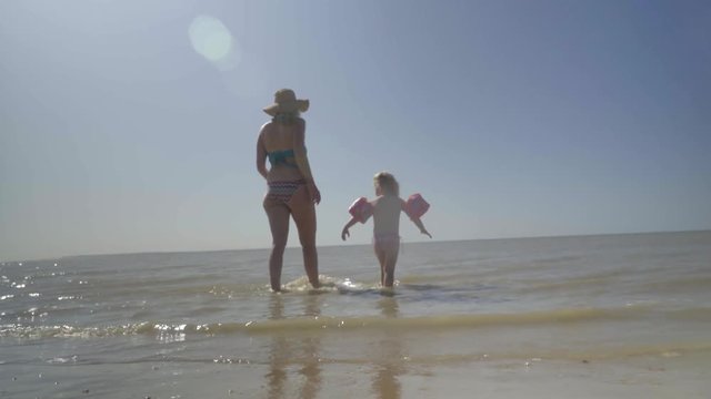 Mother in Bikini and Daughter walking into the sea - SEA / BEACH | 4K - Realistic Style