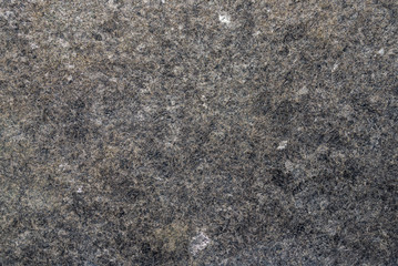 Rough and bumpy dark grey black and brown colour of Granite texture.