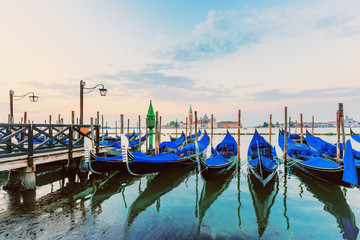 Fototapeta na wymiar Gondolas and San Giorgio Maggiore church from San Marco square at sunrise, Venice, Italy