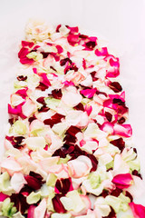 White bath with rose petals